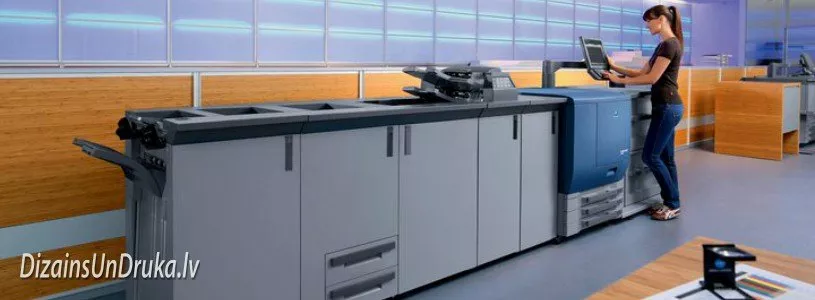 Woman operating a modern printing machine for prompt digital printing