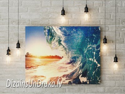 Canvas with an ocean wave and sunset motif on a light brick wall