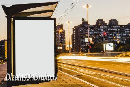 Blank advertising poster at a city bus stop against evening traffic
