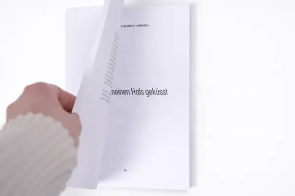 Hand turning a page in a high-quality soft cover book for custom book printing