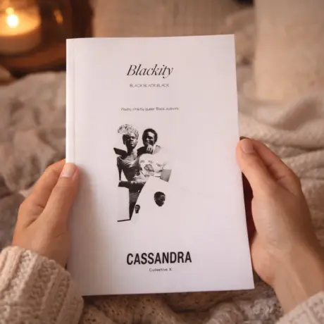 Hands holding a white soft cover book, illustrating custom book printing