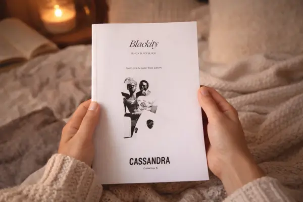 Hands holding a white soft cover book, illustrating custom book printing