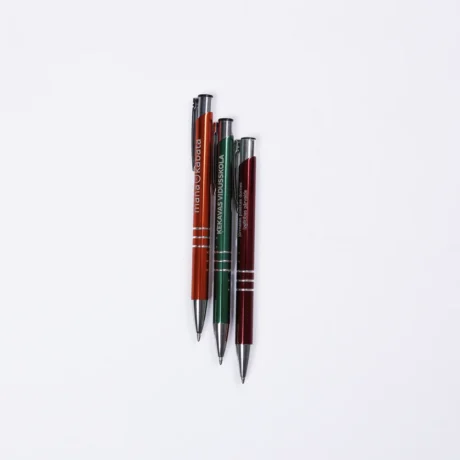 Three engraved metal pens BASIC on a white background