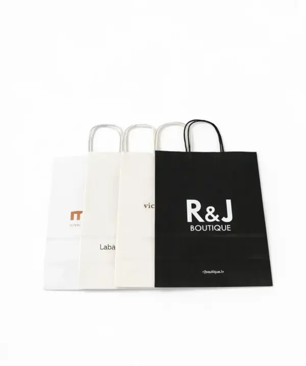 Various custom paper bags with print, including a black R&J Boutique bag