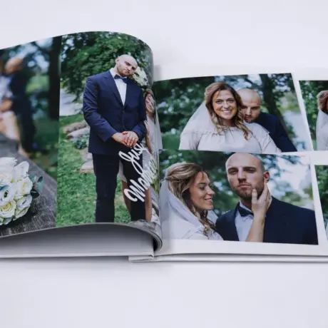 Open custom photo book with high-quality printing and wedding photos of a married couple