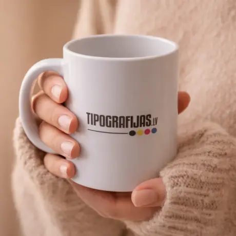 White custom mug with Tipografijas.lv print held in hands