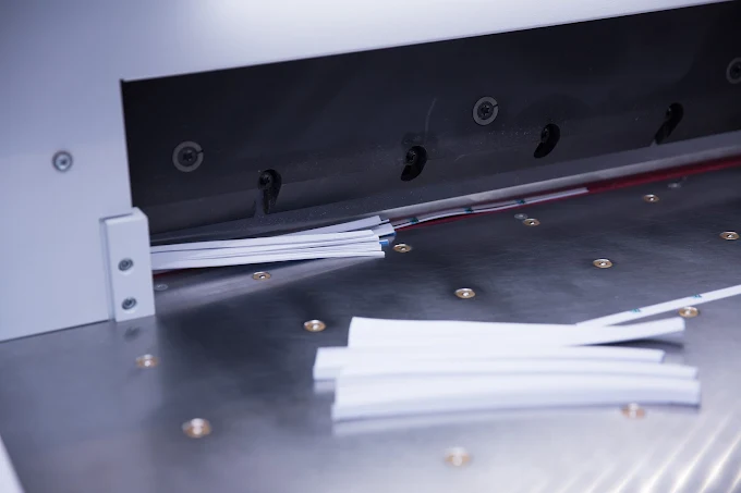 White plastic strips on the surface of a metal cutting or processing machine