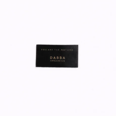 Black custom satin label with gold DABBA ORGANICS print