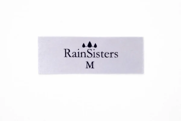 White custom satin label with black print, RainSisters logo and size M